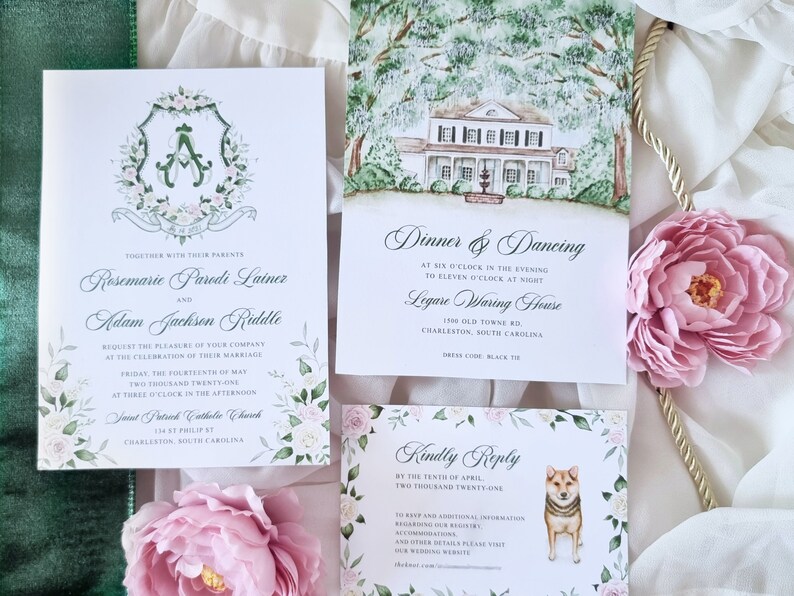 May include: Wedding invitation suite with a watercolor illustration of a house and a floral crest. The invitation includes the names Rosemarie Parodi Lainer and Adam Jackson Riddle, the date Friday, the fourteenth of May, two thousand twenty-one, and the time three o'clock in the afternoon. The invitation also includes the location Saint Patrick Catholic Church, 158 East Philip St, Charleston, South Carolina. The reception information includes the time six o'clock in the evening to eleven o'clock at night, the location Ligare Waring House, 1500 Old Towne Rd, Charleston, South Carolina, and the dress code black tie. The RSVP card includes the date by the tenth of April, two thousand twenty-one.