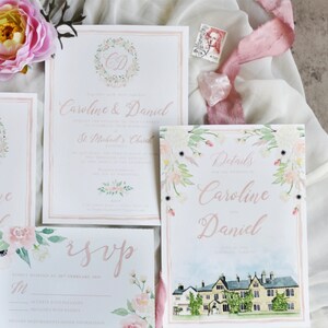 May include: Wedding invitation suite with floral watercolor designs. The main invitation features the couple's names, "Caroline & Daniel", and the details of their wedding ceremony at St. Michael's Church. The RSVP card includes a floral border and a section for guests to indicate their attendance. The details card features a watercolor illustration of a building and the text "Details for the wedding of Caroline and Daniel".