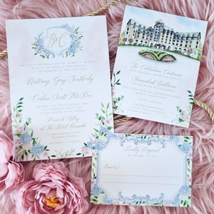 May include: A wedding invitation suite with a watercolor design featuring a floral motif and a monogram of the couple's initials. The invitation includes the names of the bride and groom, the date and time of the wedding, and the location. The RSVP card is also included.