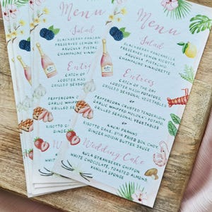 May include: A wedding menu with a tropical theme. The menu features a salad, entrees, and a wedding cake. The menu is written in a cursive font and is decorated with watercolour illustrations of flowers, fruit, and leaves.