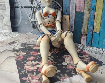 Fifi is a vintage-inspired ceramic doll with ball joints. A handmade pin-up girl sculpture to hang or sit, full of Parisian charm.