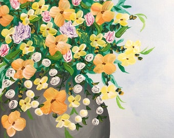 May include: A gray ceramic vase overflowing with a variety of colorful flowers, including yellow, orange, pink, and purple. The flowers are arranged in a loose, natural style, creating a vibrant and cheerful display.