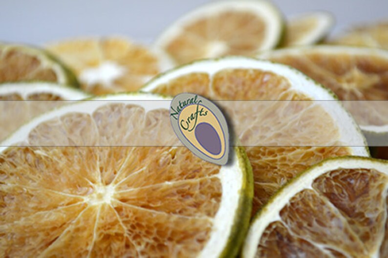 May include: Dried citrus fruit slices, arranged in a pile. The slices are a light brown color and have a translucent appearance. The fruit is arranged in a way that shows the natural texture and detail of the fruit.