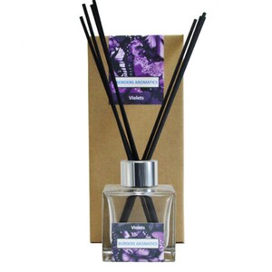May include: A glass diffuser bottle with black reeds and a brown box. The bottle has a silver cap and a label that says "Borders Aromatics" and "Violets".