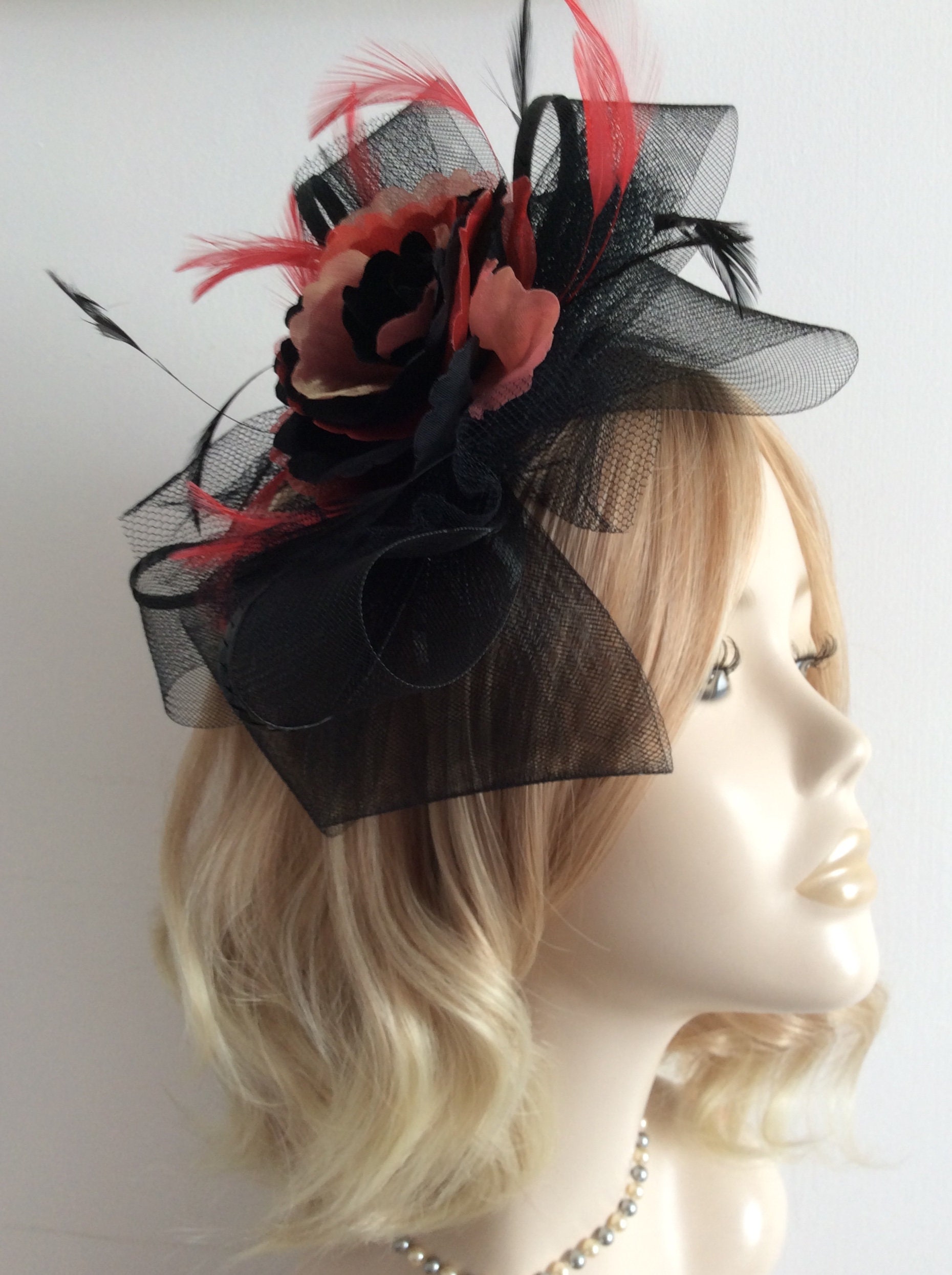 A BLACK RED and GOLD Fascinator Made of 