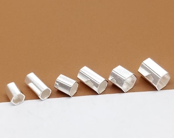 May include: Six silver hexagonal tube end caps of varying sizes. The caps are hollow and have a smooth, shiny finish.