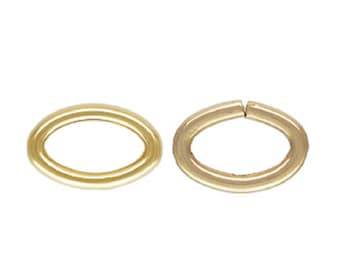 May include: Two gold oval jump rings, one is closed and the other is open.