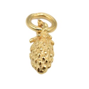 May include: A gold-coloured charm in the shape of a pineapple with a textured surface. The charm has a loop at the top for attaching to a bracelet or necklace.