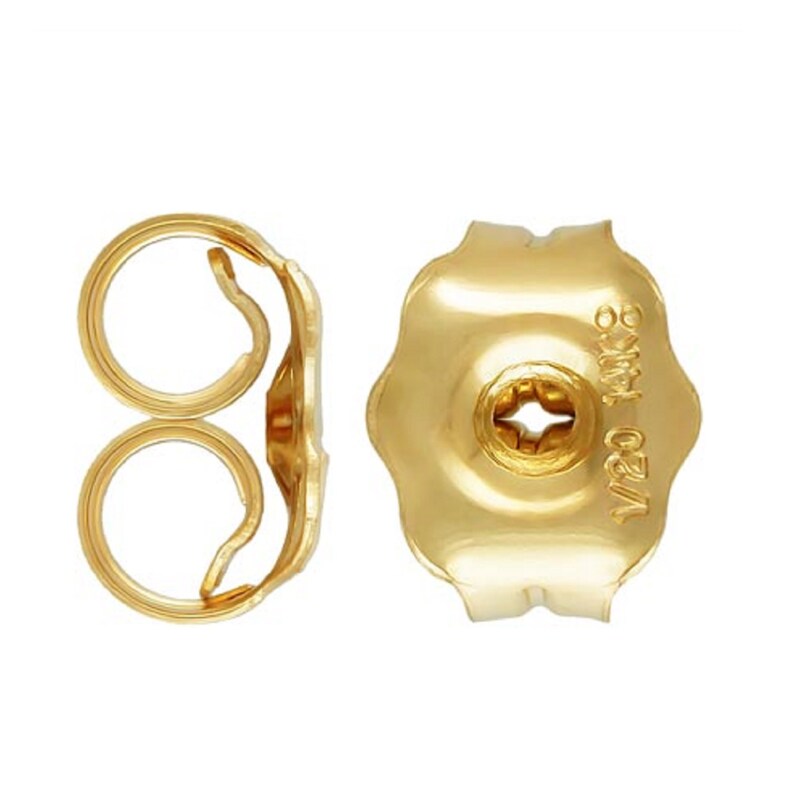 May include: A pair of gold earring backs. The back on the left is a butterfly back, and the back on the right is a push back. The push back has the inscription "14K 0.75" on the back.