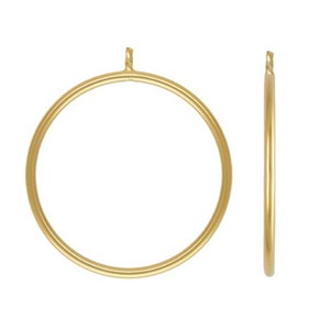 May include: A pair of gold hoop earrings. The earrings are simple and elegant, with a smooth, polished finish.