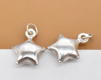 May include: Two silver star-shaped charms with a loop at the top for attaching to jewelry or other crafts.