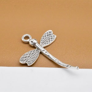 May include: Silver dragonfly charm with a loop for attaching to jewellery or other crafts.