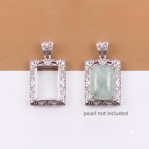 May include: Two rectangular silver pendant settings featuring intricate filigree borders and decorative bails. One setting is empty, while the other holds a smooth, pale green rectangular stone. The text pearl not included is visible.