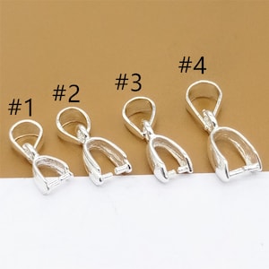 May include: Four silver-toned pendant clasps, numbered 1 to 4, with a loop at the top and a curved opening at the bottom. The clasps are arranged in a row from left to right, with the largest clasp on the right and the smallest clasp on the left.