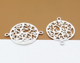 May include: Two silver-toned metal charms in the shape of a circle with a tree of life design. Each charm has three jump rings for attaching to jewelry.
