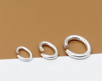 May include: Three silver jump rings of different sizes. The rings are oval shaped and have a smooth finish.