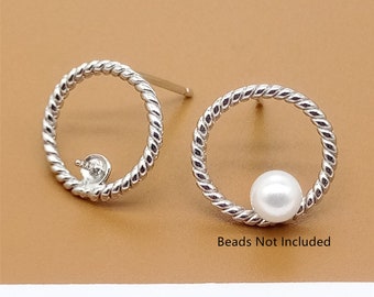 May include: Two silver hoop earrings with a twisted rope design. One earring has a white pearl bead inside the hoop. "Beads Not Included" is written below the earrings.