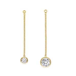 May include: A pair of gold dangle earrings with a single round clear stone at the end of each chain.
