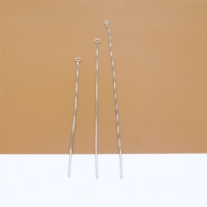 May include: Three silver chain extenders of varying lengths, each with a small loop at the top.