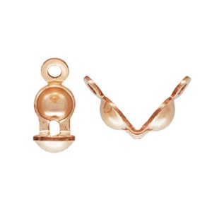 May include: Two gold-tone metal clasps for jewelry making. One clasp is open and the other is closed. Both clasps have a round ball shape.