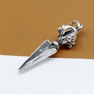 May include: Silver pendant featuring a detailed design of a dragon holding a spear. The pendant has a silver finish and is marked with the number "9769".