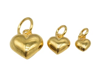 May include: Three gold heart-shaped charms of different sizes. The charms have a smooth, shiny finish and are perfect for adding a touch of elegance to jewelry.