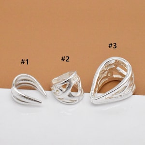 May include: Three silver pendant bails, each with a different design. The bail labeled #1 is a simple, smooth, curved shape. The bail labeled #2 has a more intricate design with cutouts. The bail labeled #3 is a teardrop shape with cutouts.