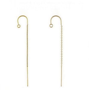 May include: A pair of gold dangle earrings with a hook closure and a long chain that ends in a thin rod.