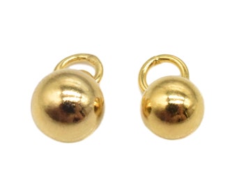 May include: Two gold-colored metal ball charms with a loop at the top. The charms are smooth and shiny.