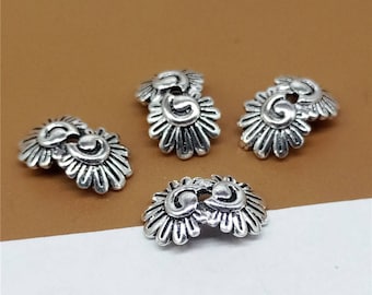 May include: Four silver-toned metal bead caps with a decorative floral design. Each cap features a double-layered flower with intricate details.