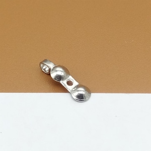 May include: Silver-toned metal jewelry finding with two round, domed ends and a loop at one end.