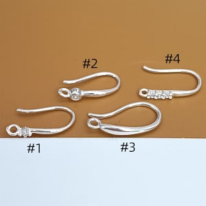 May include: Four silver earring hooks, labelled #1, #2, #3, and #4. Each hook has a different design.