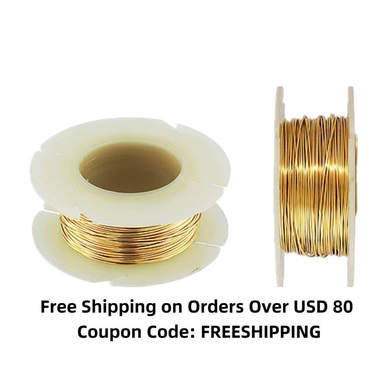 May include: Two spools of gold-colored wire, each wound around a white plastic spool. The spools are on a white background.