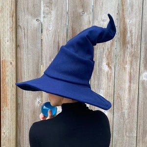 midnight blue sewn felt wizard or witch hat with a wide brim and complex folds and shaping to the cone