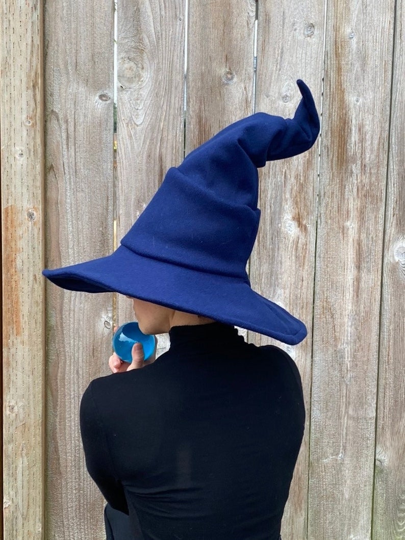 midnight blue sewn felt wizard or witch hat with a wide brim and complex folds and shaping to the cone