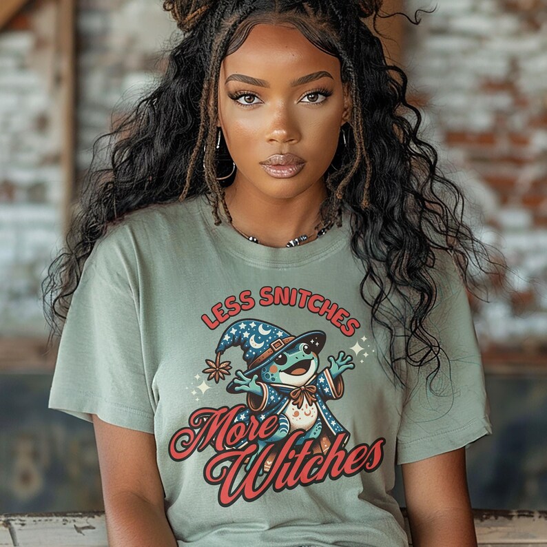 May include: A green t-shirt with a cartoon frog wearing a wizard hat and the text "Less Snitchers More Witches" in red and white.