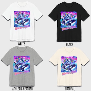 May include: A t-shirt with a graphic of two orcas jumping out of the water next to a cruise ship. The graphic is in a retro 90s style with bright colors and a rainbow. The text "Eat the Rich" is printed below the graphic. The t-shirt is available in four colors: white, black, athletic heather, and natural.