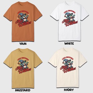 May include: Four t-shirts in different colors: mustard yellow, ivory, white, and orange. Each shirt features a cartoon illustration of a blue creature wearing a wizard hat and holding a wand. The text "Less Snitchers More Witches" is printed in red on each shirt.