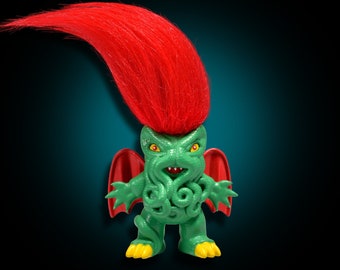 May include: A green troll toy with red wings and a red, fuzzy hairpiece. The troll has a Cthulhu-like face with tentacles.