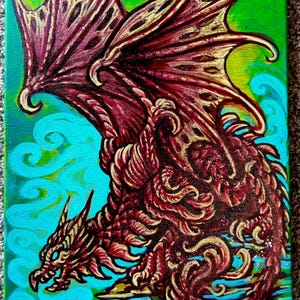 May include: A red dragon with gold accents is painted on a canvas with a blue and green background. The dragon has its wings spread out and is looking to the left. The dragon is painted in a detailed style with scales and claws.