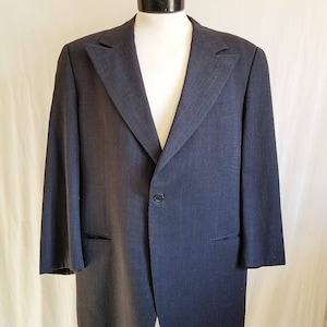 May include: A dark blue blazer with a single button closure and a classic notched lapel.