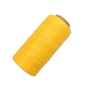 May include: A spool of bright yellow waxed thread.
