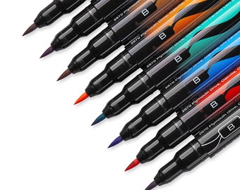 May include: A set of eight black brush pens with colourful ink. The pens have a black barrel with white text that reads "2670 Plymouth Drive, Oakville, ON Canada L6H 5R8".