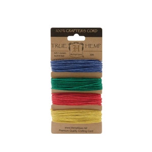 May include: A package of four spools of 100% hemp crafter's cord. The spools are in the colors blue, green, red, and yellow. The package is labeled "True Hemp" and "Hemplique".
