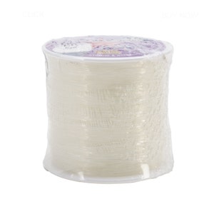 May include: A spool of clear elastic string wrapped in plastic. The string is white and translucent.