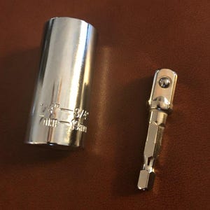 May include: A shiny, chrome socket wrench and adapter set. The socket wrench is cylindrical with size markings of 1/4" and 3/8" and 7mm-19mm. The adapter has a hexagonal base.