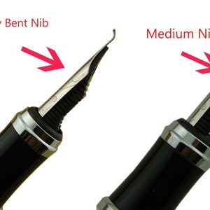 May include: Close-up of two fountain pen nibs. The nib on the left is a calligraphy bent nib. The nib on the right is a medium nib.
