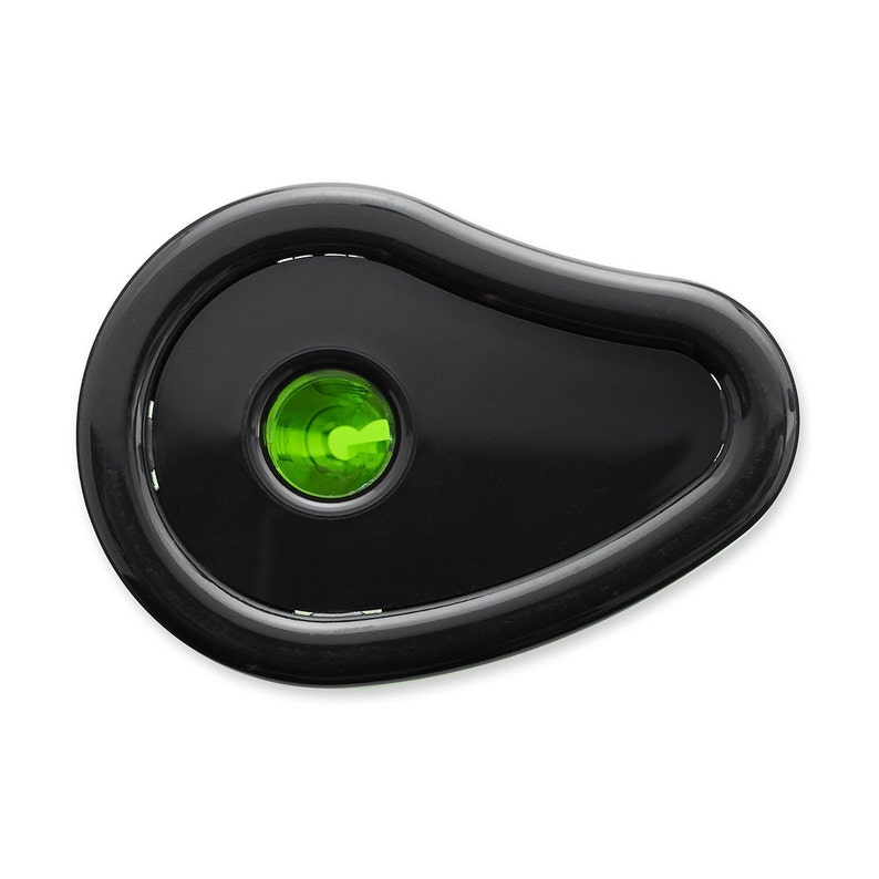 May include: Black pencil sharpener with a green plastic insert. The sharpener has a rounded, oval shape.