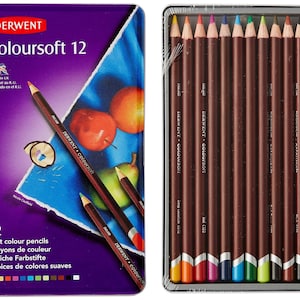 May include: A set of 12 Derwent Coloursoft soft color pencils in a metal tin. The tin is purple with the brand name and product information. The pencils are brown with colored tips, and the set includes a variety of colors.
