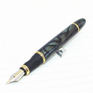 May include: A black and green fountain pen with gold accents and a fine nib. The pen has a marbled design.